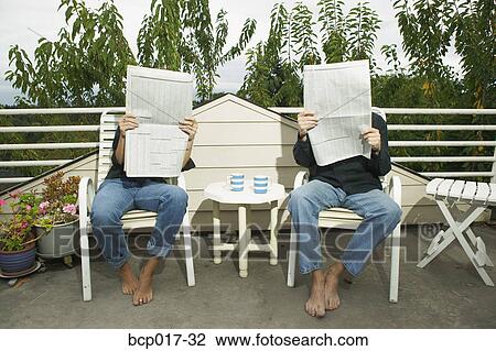 A couple reading newspapers on their porch. View Large Photo Image Stock Image - A couple reading newspapers on their porch.. Fotosearch