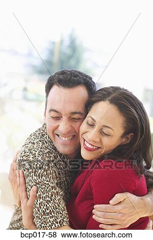 Stock Photo - A couple sharing a hug.. Fotosearch