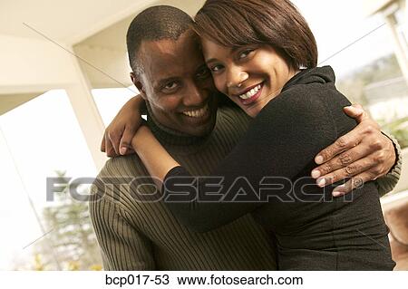 A couple smiling and hugging. View Large Photo Image Stock Image - A couple smiling and hugging.. Fotosearch