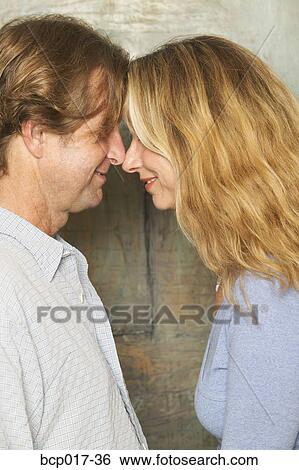 A couple with their foreheads together. View Large Photo Image Stock Photograph - A couple with their foreheads together.. Fotosearch