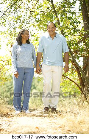 Stock Photo - Couple strolling in the country.. Fotosearch