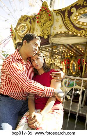 Hispanic couple in front of a carousel. View Large Photo Image Stock Photography - Hispanic couple in front of a carousel.. Fotosearch