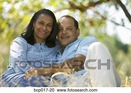 Senior couple cuddling in a park. View Large Photo Image Stock Image - Senior couple cuddling in a park.. Fotosearch