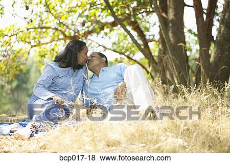 Senior couple cuddling in a park. View Large Photo Image Stock Photo - Senior couple cuddling in a park.. Fotosearch
