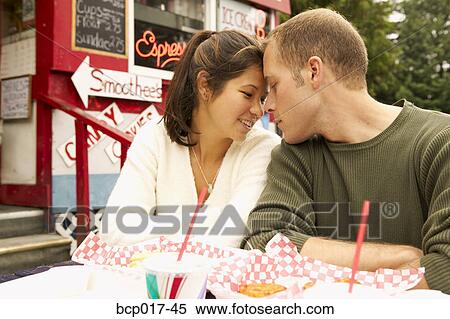 Young couple share an intimate moment outdoors. View Large Photo Image Stock Photography - Young couple share an intimate moment outdoors.. Fotosearch
