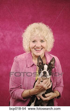 A woman holding her dog. View Large Photo Image Picture - A woman holding her dog.. Fotosearch