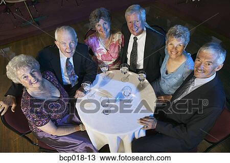 Stock Image - Overhead view of couples sitting at a nightclub table.. Fotosearch