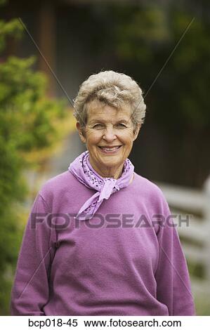 Stock Photography - Portrait of a senior woman outdoors.. Fotosearch