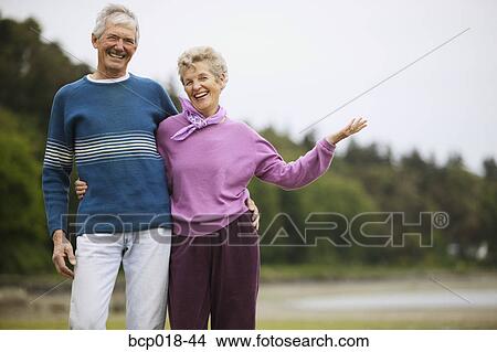 Senior couple laughing at the beach. View Large Photo Image Picture - Senior couple laughing at the beach.. Fotosearch