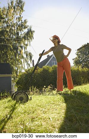 Caucasian woman mowing the lawn. View Large Photo Image Stock Image - Caucasian woman mowing the lawn.. Fotosearch