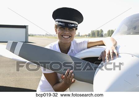 Female pilot checking her plane's propeller. View Large Photo Image Stock Image - Female pilot checking her plane's propeller.. Fotosearch