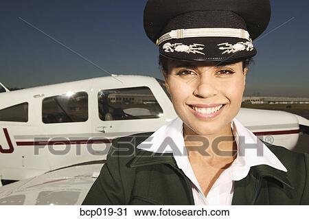 Female pilot in front of her small airplane. View Large Photo Image Stock Image - Female pilot in front of her small airplane.. Fotosearch