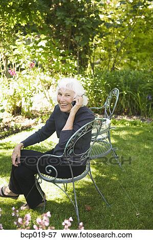 Senior woman talking on her mobile phone. View Large Photo Image Stock Photo - Senior woman talking on her mobile phone.. Fotosearch