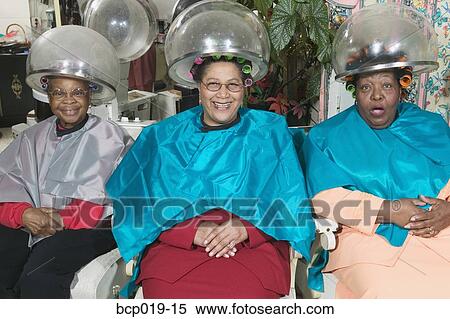 Three senior women sitting under hairdryers. View Large Photo Image Stock Photography - Three senior women sitting under hairdryers.. Fotosearch