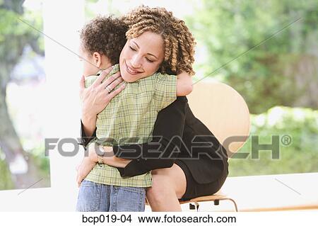 Picture - Woman hugging her young son.. Fotosearch