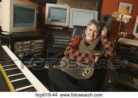 Woman in a computerized recording studio. View Large Photo Image Picture - Woman in a computerized recording studio.. Fotosearch