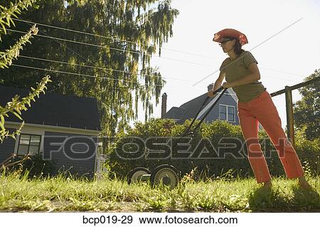 Woman mowing her lawn. View Large Photo Image Stock Photo - Woman mowing her lawn.. Fotosearch