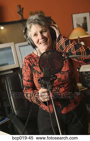 Woman singing in a recording studio. View Large Photo Image Stock Photography - Woman singing in a recording studio.. Fotosearch