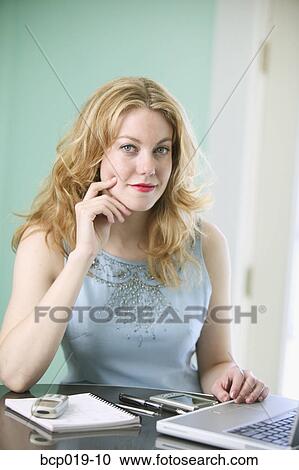Woman sitting at table with laptop. View Large Photo Image Stock Image - Woman sitting at table with laptop.. Fotosearch