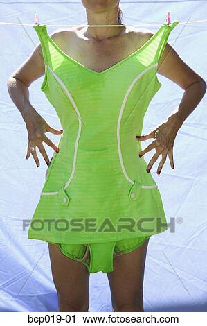 Woman standing behind vintage swimsuit on a clothesline. View Large Photo Image Stock Image - Woman standing behind vintage swimsuit on a clothesline.. Fotosearch