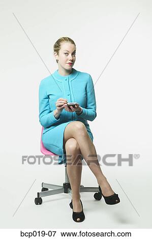 Stock Photo - Young woman working with PDA. Fotosearch