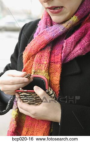 A woman counts the change in her coin purse. View Large Photo Image Stock Photograph - A woman counts the change in her coin purse.. Fotosearch
