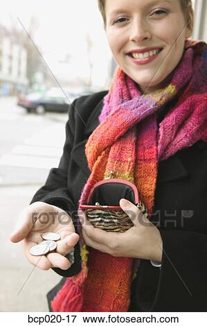 A woman holding out coins. View Large Photo Image Stock Photo - A woman holding out coins.. Fotosearch