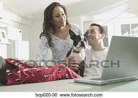 Couple working together on a laptop computer. View Large Photo Image Stock Image - Couple working together on a laptop computer.. Fotosearch