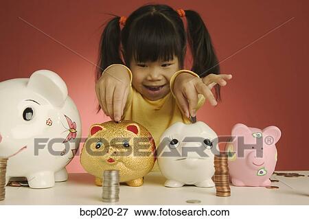 Little girl putting coins into piggy banks View Large Photo Image Stock Photo - Little girl putting coins into piggy banks. Fotosearch