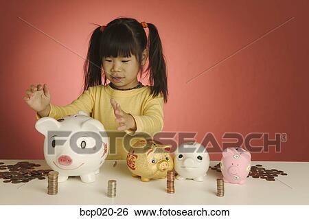 Little girl with stacks of coins and piggybanks. View Large Photo Image Stock Photograph - Little girl with stacks of coins and piggybanks.. Fotosearch