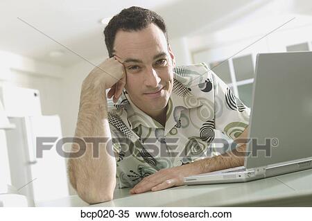 Man at home with his laptop computer. View Large Photo Image Stock Photography - Man at home with his laptop computer.. Fotosearch