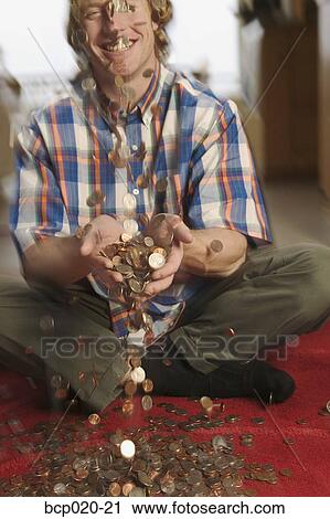 Man catching falling coins. View Large Photo Image Stock Image - Man catching falling coins.. Fotosearch