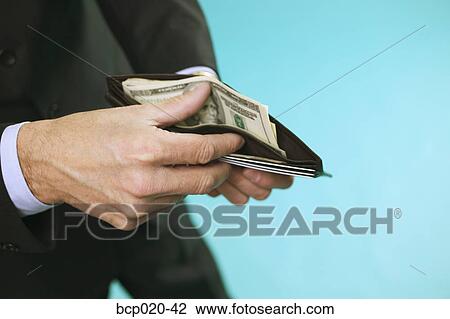 Man checking the cash in his wallet. View Large Photo Image Stock Image - Man checking the cash in his wallet.. Fotosearch