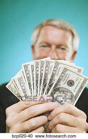 Man holding a fan of money. View Large Photo Image Stock Image - Man holding a fan of money.. Fotosearch