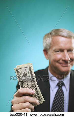 Man with a stack of money. View Large Photo Image Stock Image - Man with a stack of money.. Fotosearch