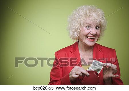 Senior woman pulling money from her purse. View Large Photo Image Stock Photography - Senior woman pulling money from her purse.. Fotosearch