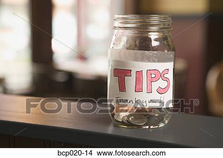 Still life of a nearly empty tip jar. View Large Photo Image Picture - Still life of a nearly empty tip jar.. Fotosearch