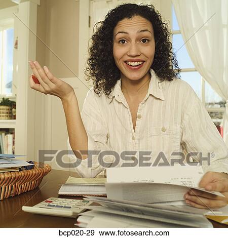 Woman working at home on personal finances. View Large Photo Image Stock Photo - Woman working at home on personal finances.. Fotosearch
