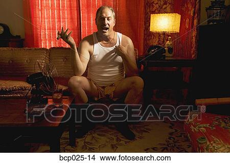 A man in his underwear smoking a cigar View Large Photo Image Picture - A man in his underwear smoking a cigar. Fotosearch