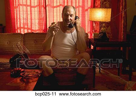 A man in his underwear smoking a cigar View Large Photo Image Stock Image - A man in his underwear smoking a cigar. Fotosearch
