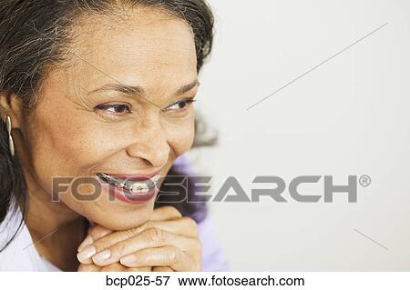 Stock Photo - A middle-aged woman with braces. Fotosearch