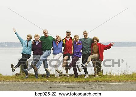 Stock Image - Eight middle-aged men and women in a row. Fotosearch