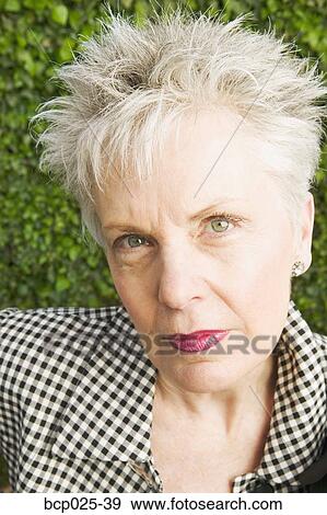 Headshot of a middle-aged woman View Large Photo Image Stock Photo - Headshot of a middle-aged woman. Fotosearch