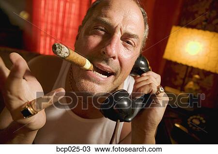 Man with a cigar in his mouth View Large Photo Image Stock Image - Man with a cigar in his mouth. Fotosearch