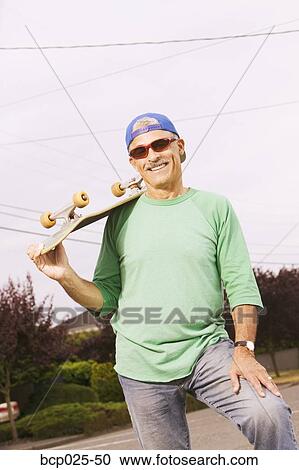 Middle-aged man with his skateboard View Large Photo Image Stock Image - Middle-aged man with his skateboard. Fotosearch