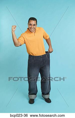 Stock Photograph - Man wearing pants that are too large. Fotosearch