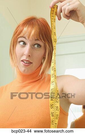 Measuring tape and young woman View Large Photo Image Picture - Measuring tape and young woman. Fotosearch
