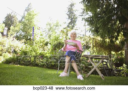 Stock Photo - Senior woman eating a healthy salad. Fotosearch