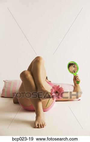 Woman lying down with a flower between her toes View Large Photo Image Stock Photo - Woman lying down with a flower between her toes. Fotosearch