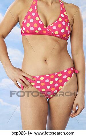 Picture - Woman wearing pink polka dot bikini. Fotosearch